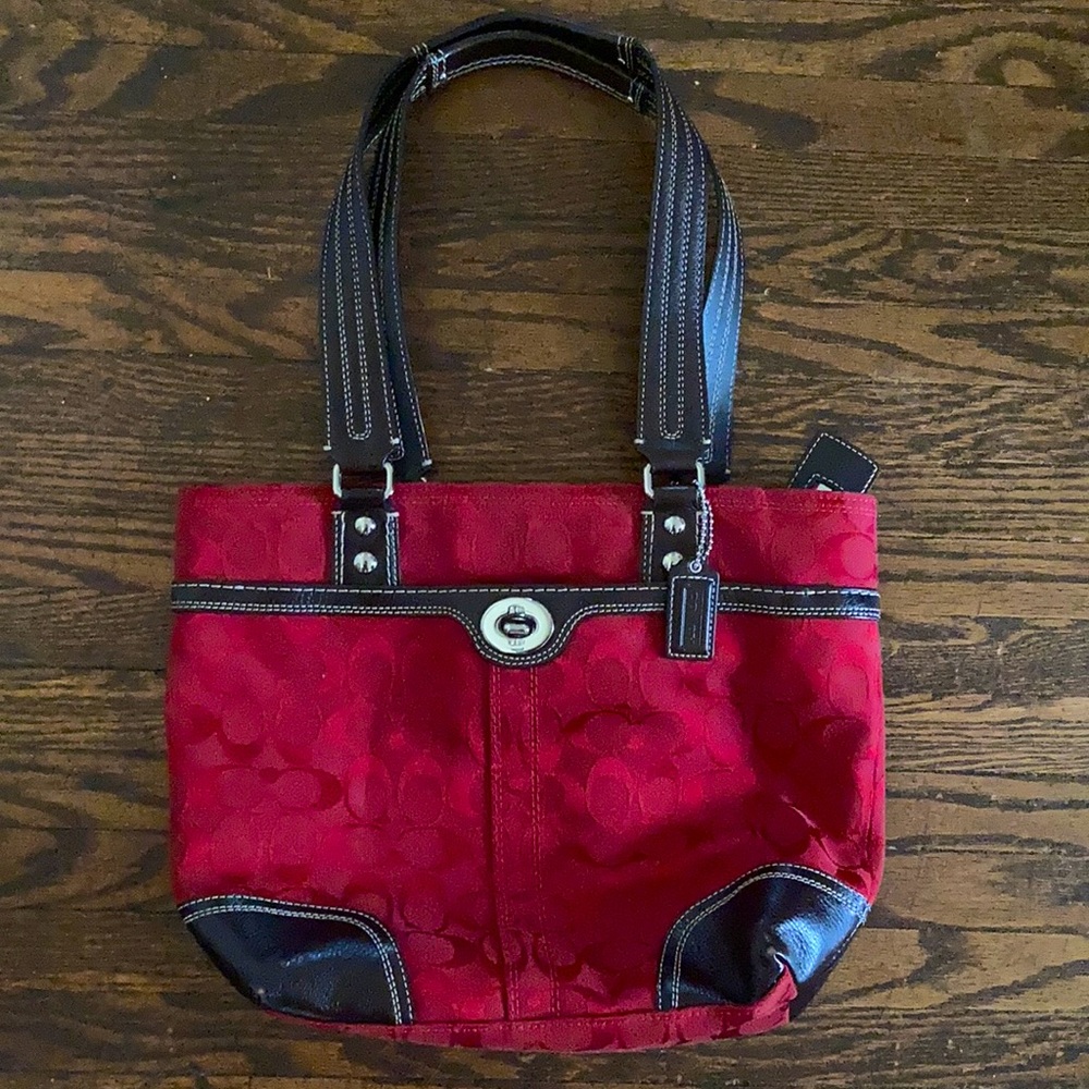 Red Coach purse with brown leather trim.
